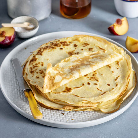 crepe recipe - stack of crepes on a plate