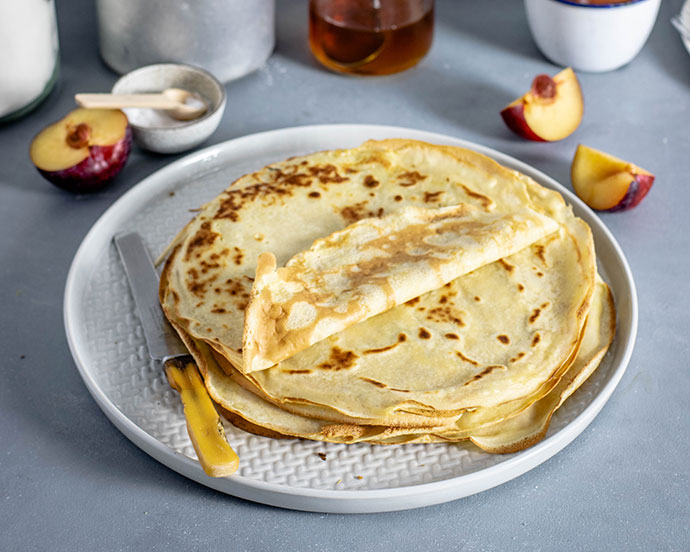 crepe recipe - stack of crepes on a plate