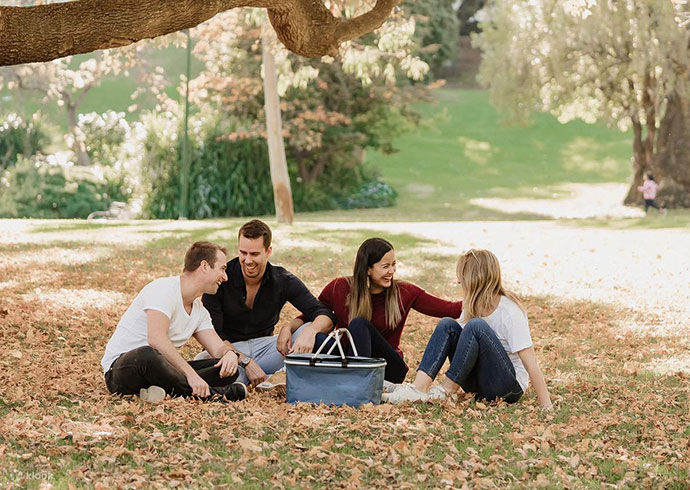 group of people enjoying a picnic under a tree 