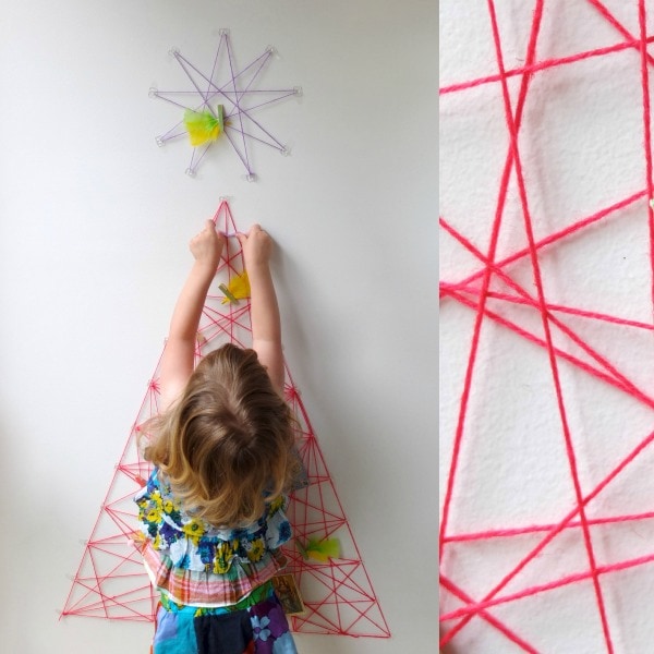 child decorating christmas tree