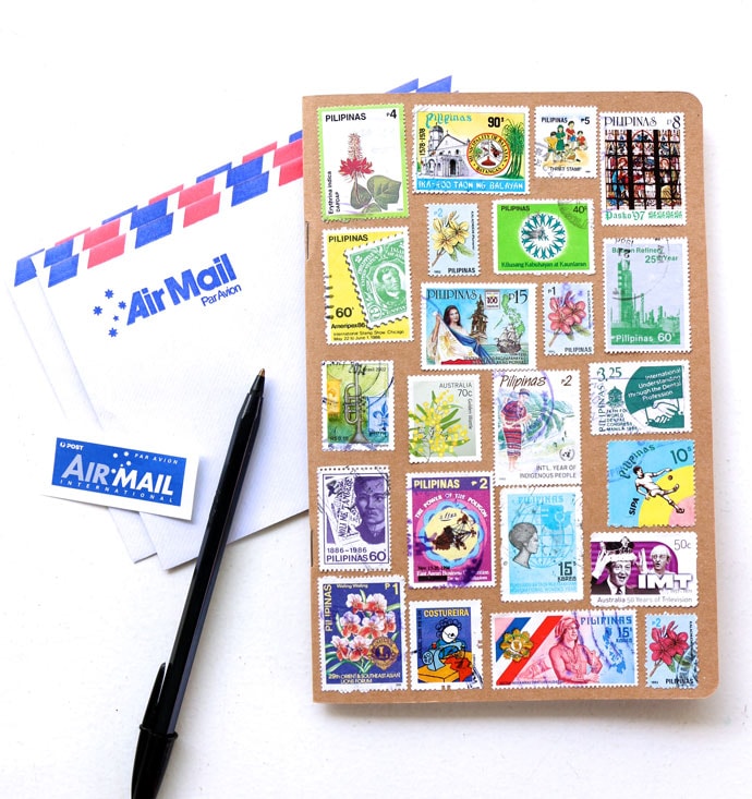 Upcycle old stamps to decorate a notebook