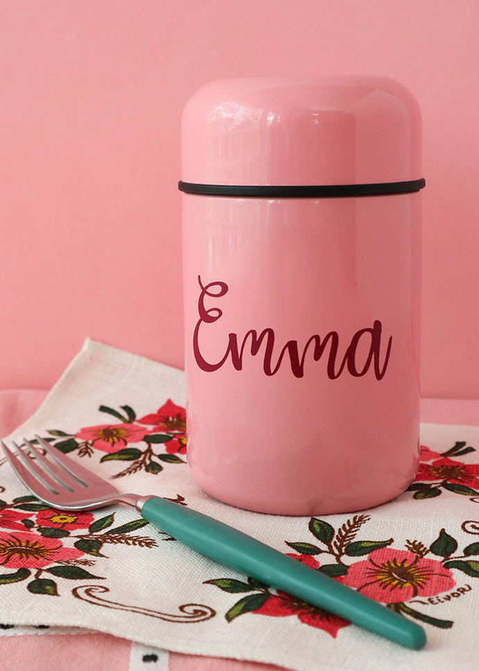 Pink thermos container on floral napkin