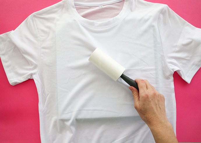 Using lint roller on t-shirt