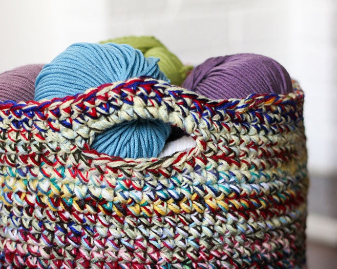 crochet basket filled with balls of yarn