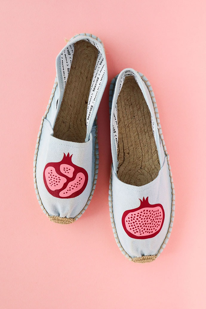 blue espadrilles with fruit design on pink background