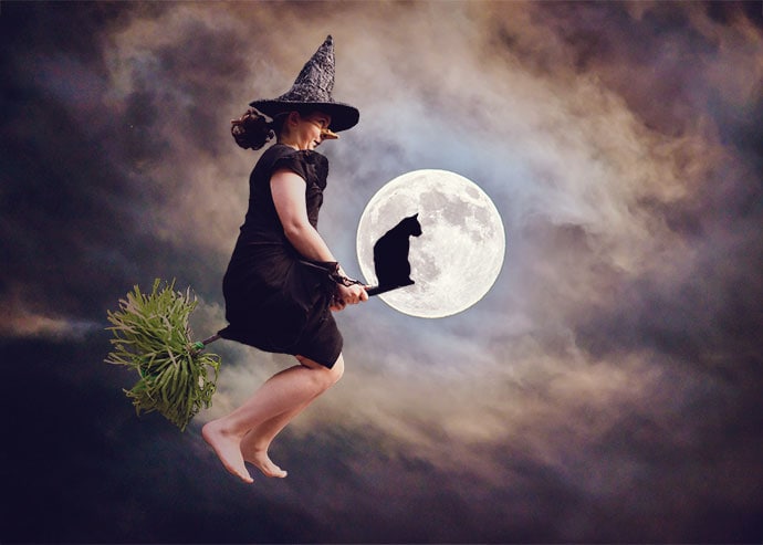 Girl flying on a broom in front of a full moon