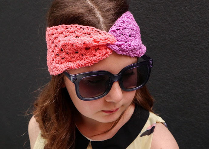 Girl wearing a crochet headband - colour blocked granny square headband