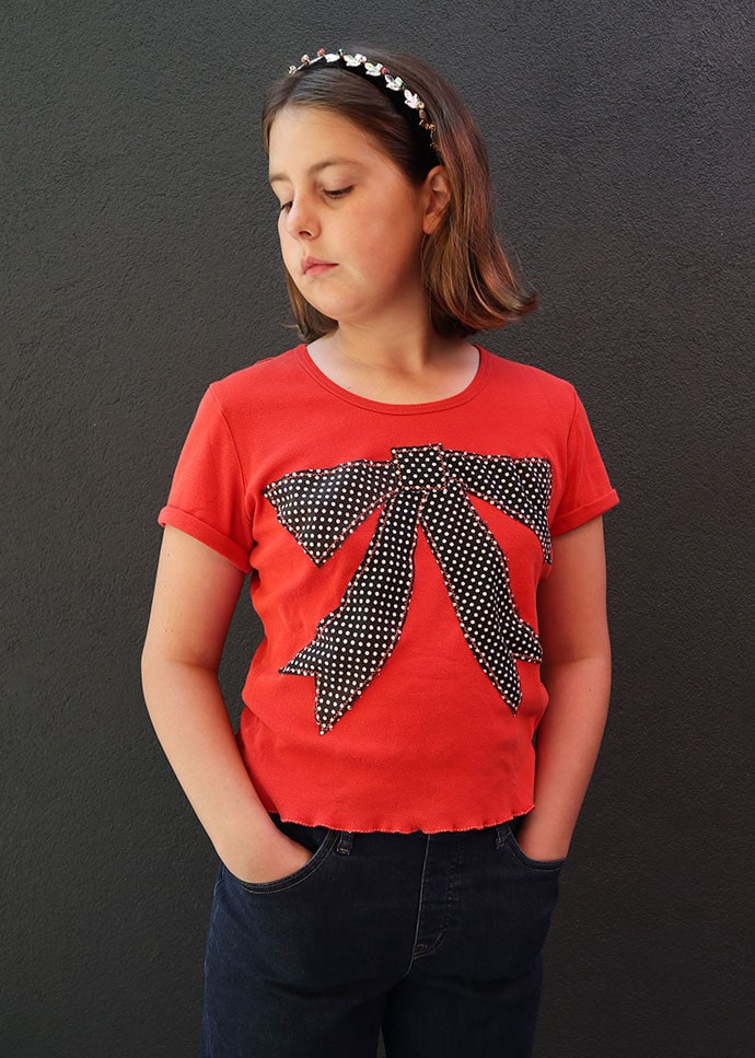 t shirt refashion idea - girl wearing and orange tshirt with large bow applique