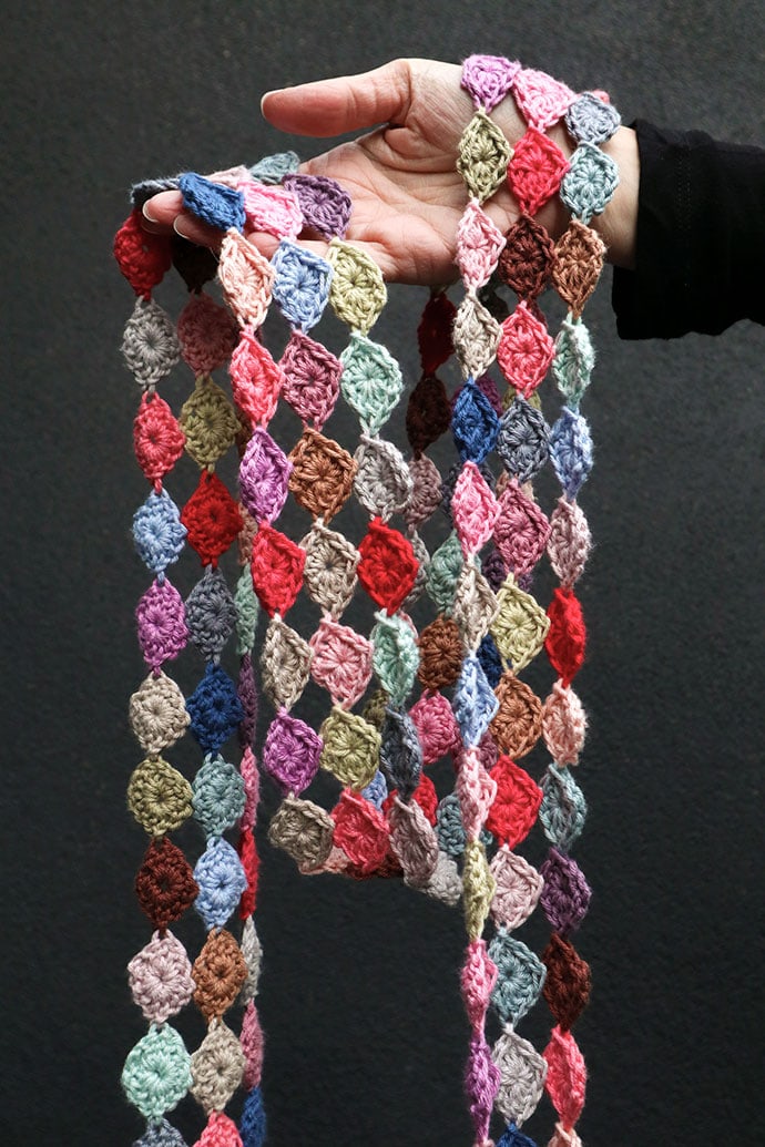 hand holding spotty crochet scarf