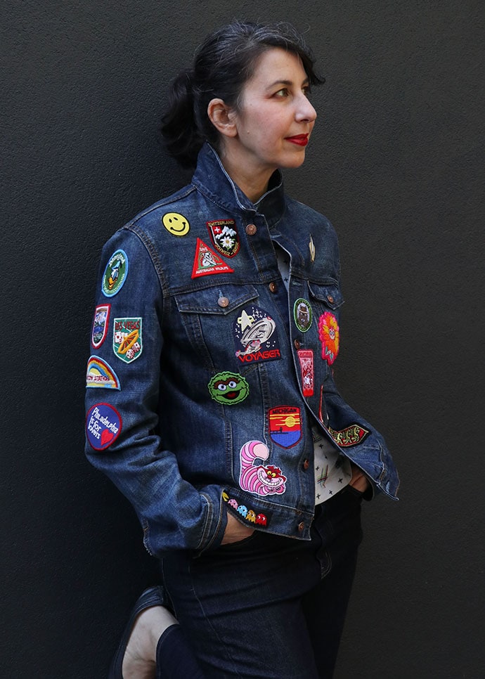 woman wearing denim jacket covered with patches