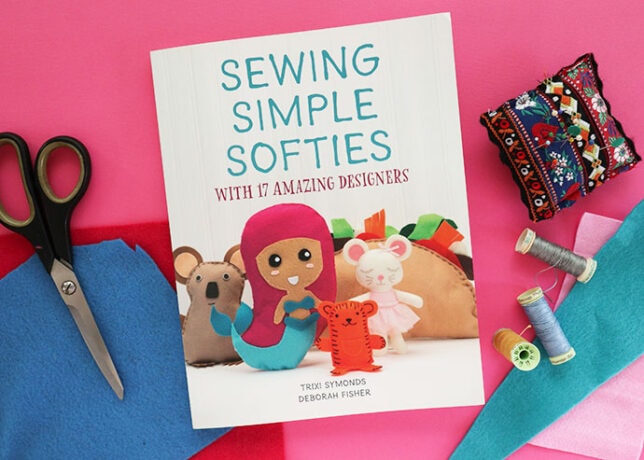 Front cover Sewing Simple Softies craft book with scissors and thread in background
