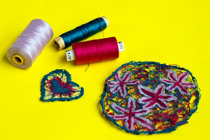 sample of free motion embroidery and thread spools