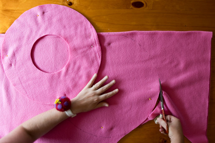 cutting out beret from pink fabric