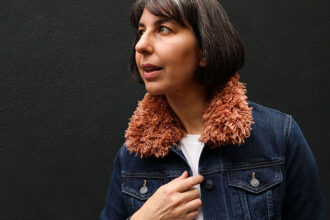 woman wearing a denim jacket with brown crochet fur collar