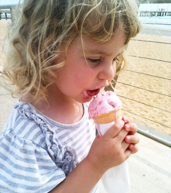 girl eating strawberry ice cream