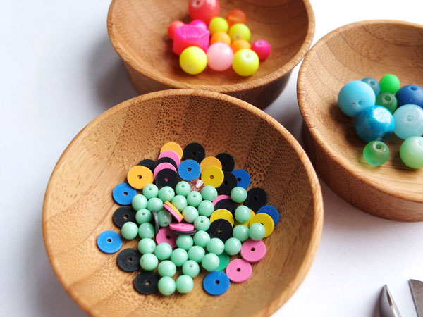 Colourful beads in wooden bowls